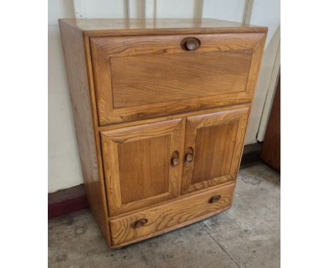 An Ercol Blonde elm Windsor writing cabinet 