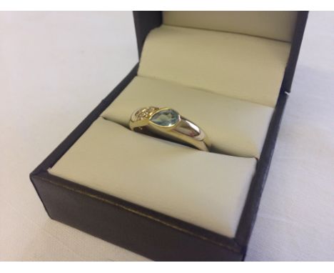 A 9ct gold dress ring set with blue topaz and diamonds, size O.