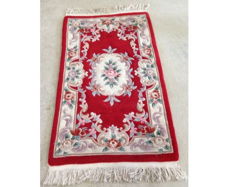 Red woollen rug approx 170cm x 92cm.