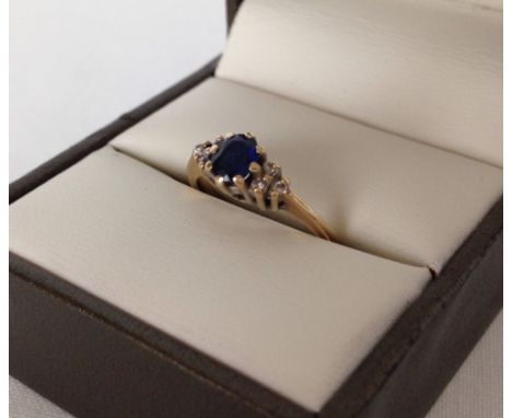 Hallmarked 9ct gold ladies ring set with sapphire and diamonds. Size K, weight approx 1.9g