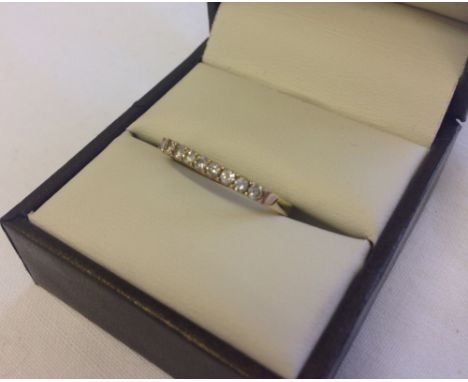 A 9ct gold 1/2 eternity ring set with 9 diamonds, size Q.