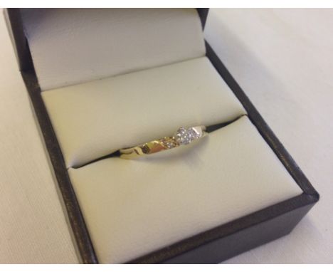 A 9ct gold central diamond ring with small diamonds on shoulders, size N.