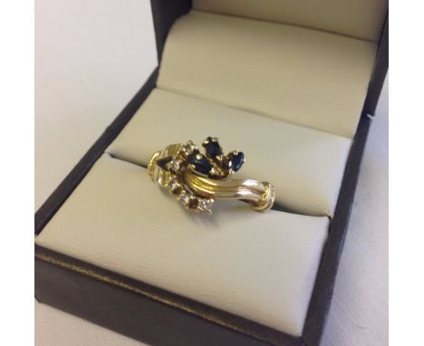 An 18ct gold sapphire & diamond dress ring. Size P 1/2.