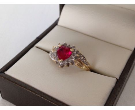 Hallmarked 9ct gold ladies dress ring set with a heart shaped created ruby and 3 small diamonds. Size M1/2, weight approx 2.4