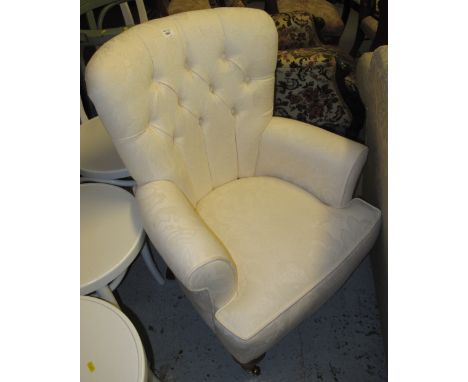 Modern cream upholstered button back arm chair.