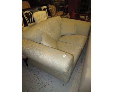 Modern foliate upholstered two seater sofa with scroll arms and matching cushions.