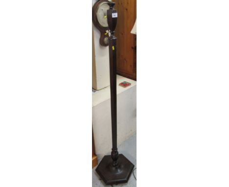 Stained mahogany standard lamp on hexagonal base.