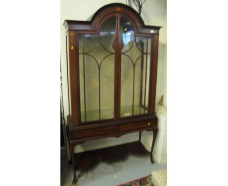 Edwardian mahogany inlaid astragal glazed, arch topped display cabinet with under shelf on cabriole legs.