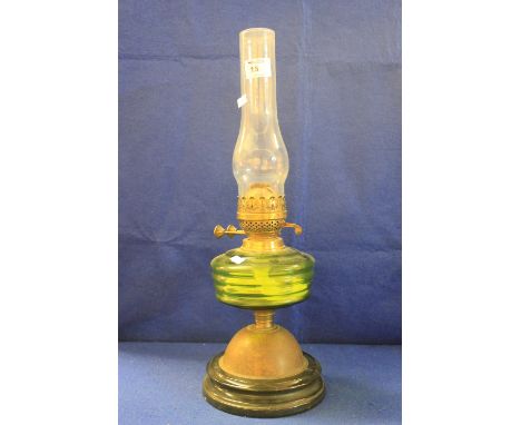 Early 20th Century double oil lamp with green glass reservoir.