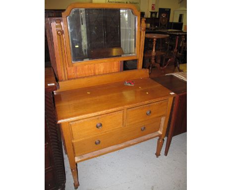 Early 20th Century oak bevel plate mirror back dressing table with fitted drawers on ceramic casters.