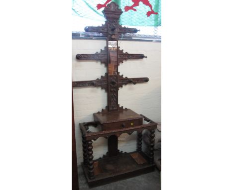 Early 20th Century oak, relief foliate and florally carved hall stand on bobbin turned legs and supports.