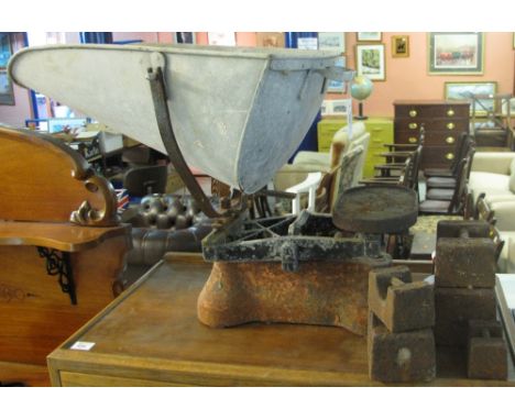 Large vintage weighing scales together with a set of graduated weights.