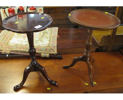 Reproduction mahogany tripod wine table together with a similar circular tripod wine table with leather insert top.  (2)