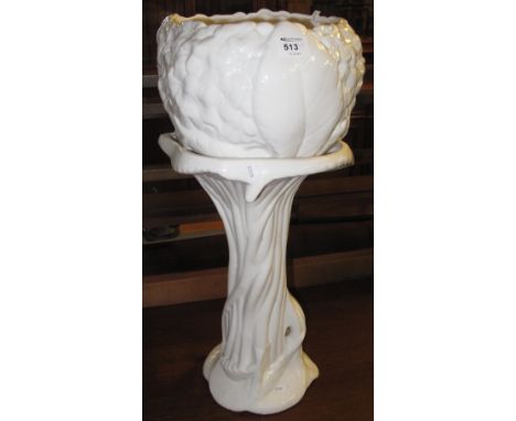 White ceramic relief organic design jardiniere on stand.