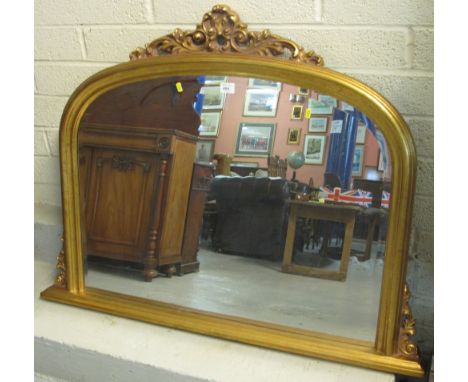 Modern bevel plate arch top scroll decorated oval mantle mirror.