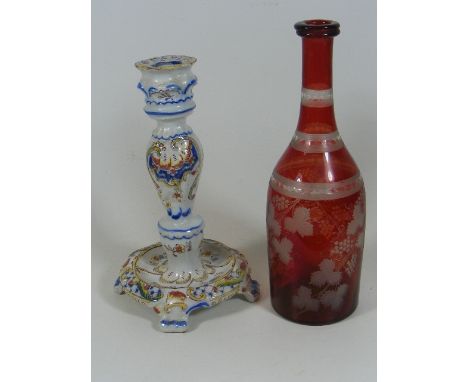 A French Faience Candlestick Twinned With An Antique Bohemian Glass Wine Bottle