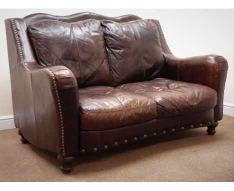 Two seat traditional sofa upholstered in brown studded leather, shaped back, serpentine front, turned supports, W158cm Condit