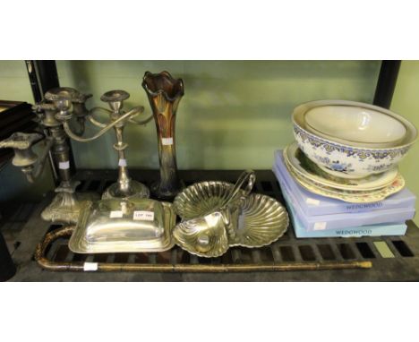 A shelf containing silver plate candelabra, a black vase, Wedgwood China, small cane etc