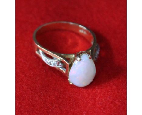 An 18ct gold ring set tear drop Opal and diamonds to the shoulders