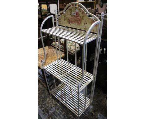 A modern metal folding three shelf plant pot stand