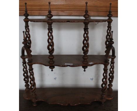 An olive wood three tier ornate shelf unit