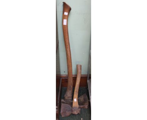 A vintage wooden long shafted axe with a smaller example