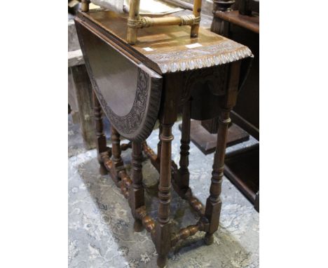 A late 19th century gate fold oval table with carved and decorative edging