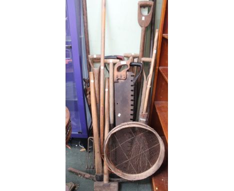A good selection of mainly wooden shafted garden and hand tools