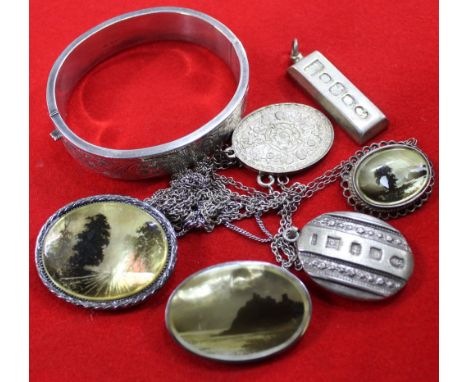 A selection of jewellery, includes two 1977 silver ingot pendants. a silver bangle, together with three landscape painted Mot