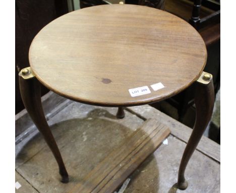 A small circular tripod table with brass fittings