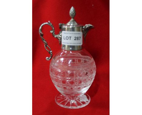 A globular engraved crystal jug, (Whisky toddy?) with band of geometric decoration and star cut base. The neck is encased wit