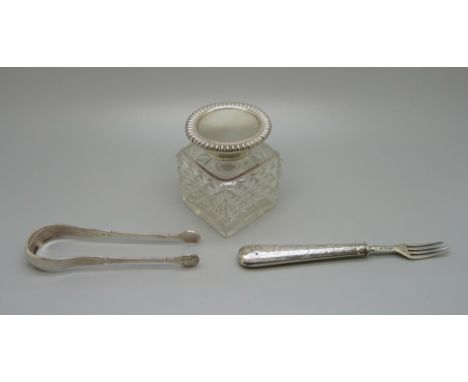 A silver topped inkwell, glass chipped, a Victorian silver fork, a salt spoon and a pair of sugar bows 