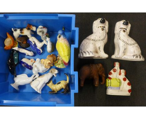 A pair of Staffordshire Spaniels, a pair of greyhounds, one sheep, a Poole Pottery dolphin, an owl, and other animal figures 