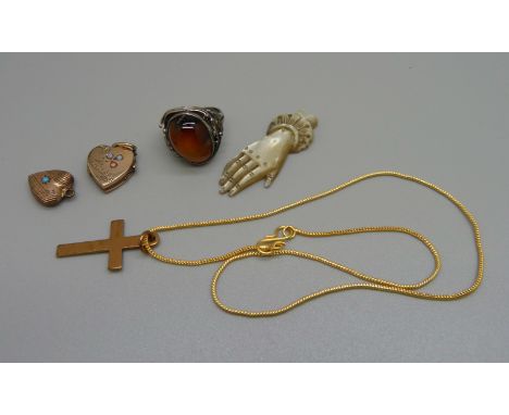 A silver and amber ring, a cross pendant, an opal set heart shaped locket, a pendant and a carved mother of pearl hand, a/f 