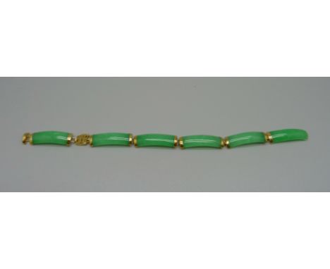 A 14k gold mounted jade bracelet, requires repair 