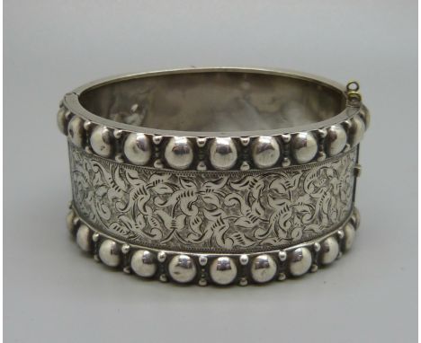 A Victorian white metal bangle, dented 