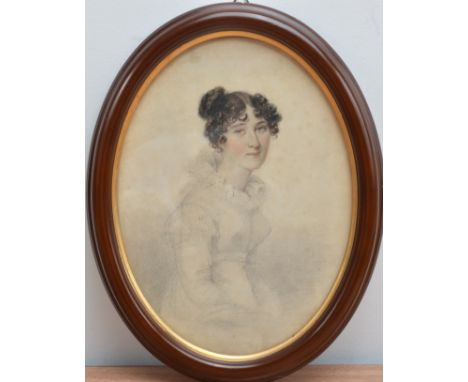 A 19th century Portrait of a young lady, Charcoal on paper, in a oval frame, the reverse with a hand written piece of paper s