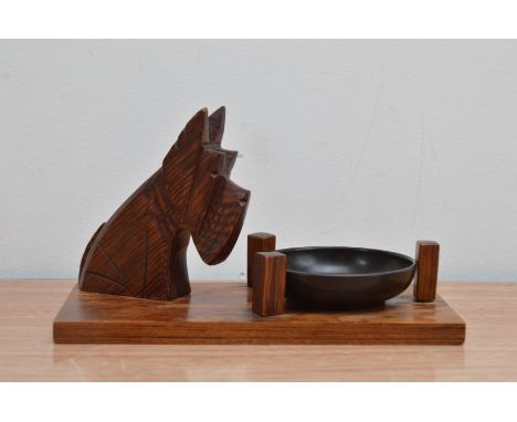 A 20th century Art deco style dog pin tray, the dog a Scottish terrier, with a removable Bakelite circular tray, all on a rec