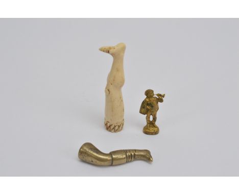 Three 19th century novelty pipe tampers, comprising a bone example in the form of a human leg, 6.5cm in length, a brass examp