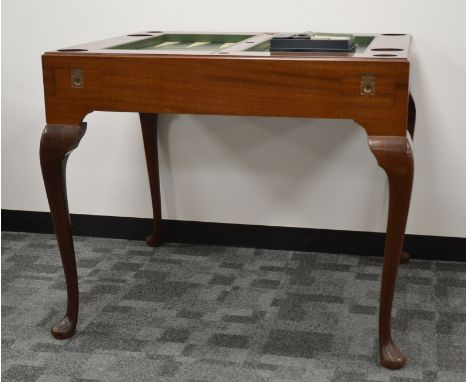 A 1970's Dunhill walnut veneered backgammon table and leatherette counters, removable cover, with baize underside, leatherett