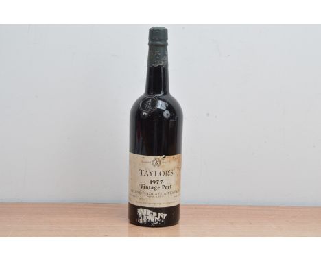 A bottle of Taylor's 1977 Vintage Port, fill level appears good 