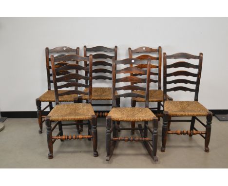 Six stained 19th century oak rush seated chairs, ladder backed, one converted to a rocker, 95cm H x 48cm W x 43cm D (6) 