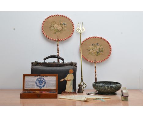 A collection of works of art, comprising a pair of ladies hand-held fire screens, floral needlework, a brass fork, 51cm long,