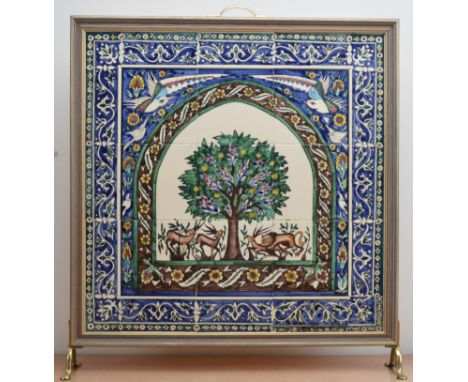 A 20th century ceramic tile fire screen, the tiles depicting wild animals and a central tree, with a foliate scrolling border