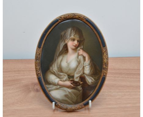 A 19th century hand painted Berlin style porcelain plaque, depicting a girl with a lamp, in an oval gilt and ebonised frame, 