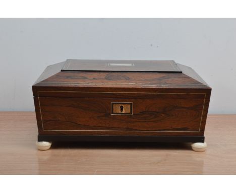 A 19th century Rosewood sewing box, the lid with a mother of pearl rectangular cartouche, ivory string work, the interior wit