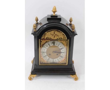 Late 19th century bracket clock with 8 day striking movement, arched brass dial with cast spandrels in ebonized case with bra