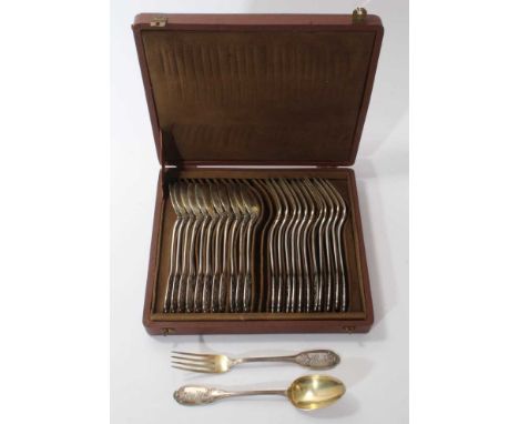 Early 20th century French silver gilt dessert service, comprising 12 pairs dessert spoons and forks, with raised floral decor