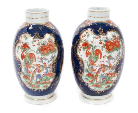 A pair of Worcester tea canisters, circa 1770, richly painted in Kakiemon style with a dragon and phoenix pattern, on a blue 