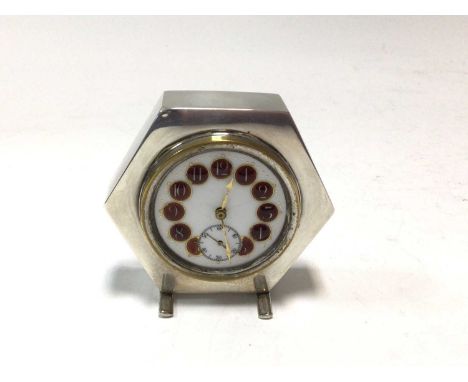 1940s silver desk clock of hexagonal form, with a Swiss movement and white enamel dial, with red enamelled numerals and subsi